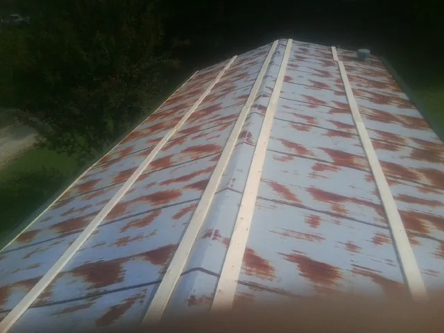 Rusted metal roof panels with new wood purlins before replacement — Storm Damage Roof Repair in Midlothian by Roofing Brothers